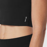 Black cropped tee worn by model, side view showing fit and midriff