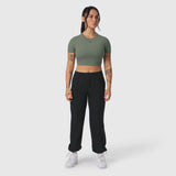 Sage green cropped tee paired with black joggers, modeled with white sneakers