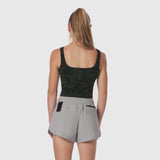 Lycra 2-in-1 tank top in dark camo worn with grey shorts, back view