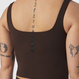 LYCRA® 2-in-1 Tank Top in Dark Earth, worn by model showing back view with tattoos