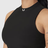 Black ribbed mockneck tank top worn by model, side view showing fit and fabric texture