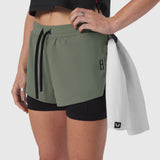 Tetra-Lite® Liner Short in sage green with black undershorts, worn with white jacket draped over shoulder
