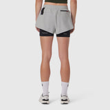 Tetra-Lite Liner Short in slate grey and black, back view on model wearing white socks and sneakers