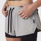 Tetra-Lite Liner Short in slate grey being worn and adjusted by model, front view