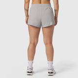 Aerotex Side Split Run Short in slate grey, back view on model with white socks and sneakers