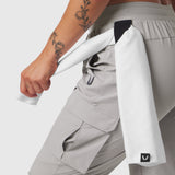 Tetra-Lite® Cargo High Rib Jogger in Slate Grey, worn with white jacket, side view
