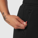 Black Sorona® Terry straight leg sweats worn by model, detail of hand and zipper pocket