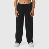 Black Sorona® Terry straight leg sweats on model, front view with white sneakers