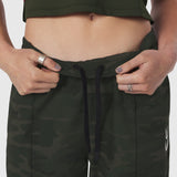 W036 Ripstop Relaxed Track Pant in Dark Camo, model wearing and adjusting waistband