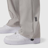 W036 Ripstop Relaxed Track Pant in slate grey worn with white sneakers, detail view of ankle cuff