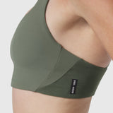 Lycra Hybrid Sports Bra in sage, worn on model, side view