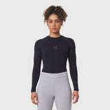 LYCRA® ADAPTIV Baselayer Longsleeve in black, worn with grey leggings, front view