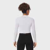 White LYCRA® ADAPTIV baselayer longsleeve worn with black leggings, back view
