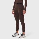W059 Hybrid Belt-Pack Run Legging in dark earth brown, worn with white sneakers, front view