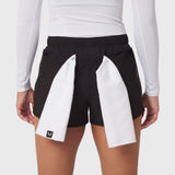 Tetra-Lite Adventure Short in black with white panel details, worn by model with white long-sleeve top