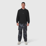 Black Tetra-Lite® Blade Collar Zip Jacket worn with patterned cargo pants, front view on model
