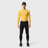 LYCRA® ADAPTIV Baselayer Longsleeve in amber yellow worn with black leggings, front view