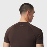 LYCRA® ADAPTIV Baselayer Shortsleeve in Dark Earth, back view on model