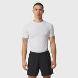 White LYCRA® ADAPTIV baselayer shortsleeve t-shirt worn with black shorts, front view on model
