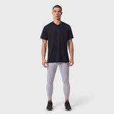 Black v-neck t-shirt with grey leggings and black sneakers, front view on model