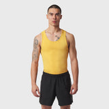 LYCRA® ADAPTIV Baselayer Tank in amber yellow worn with black shorts, front view on model