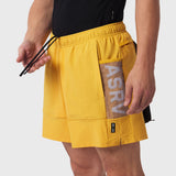 Tetra-Lite Adventure Short in amber yellow, worn by model holding drawstring, side view