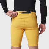 Lycra Ribbed Run Half-Tight in amber yellow worn by model, front view with hand in pocket