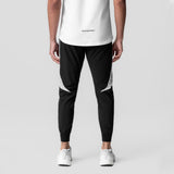 Black and white cuffed training jogger worn by model, back view