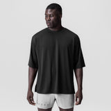 Black oversized tee with white shorts on model, front view