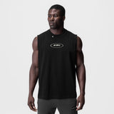 Black ASRV Tech Essential relaxed cutoff tank top worn by male model, front view
