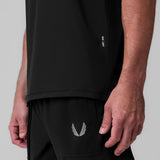 Tetra-Lite® Ice Zip Tee in black worn by model, side view showing fit and winged logo