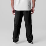 Tetra-Lite Field Pant in black, back view on model wearing white tee
