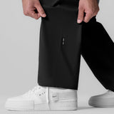 Black Tetra-Lite Field Pant worn with white sneakers, front view detail