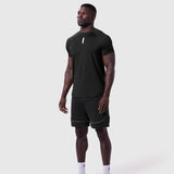 AeroSilver Established Tee in black worn with black shorts, front view on model