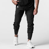 Black High Rib Jogger worn by model with white sneakers, front view