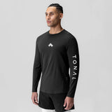 Black long sleeve shirt with TONAL branding on sleeve, worn by model, front view