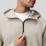 Dri-Core™ Zip Hoodie in Chai worn by model, front view with hand on zipper
