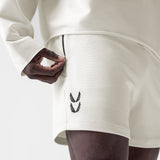 Waffle Knit Sweat Short in cream, worn by model with hand in pocket, side view