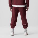Tech-Terry Oversized Sweats in crimson worn by model, back view with white socks and sneakers