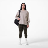 Tech Essential Relaxed Long Sleeve in Faded Chai worn with camo leggings and white socks