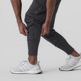 Tech-Terry Cargo High Rib Jogger in Dusk Black, worn with white sneakers, front view