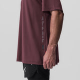 AeroSilver Oversized Tee in plum worn with black shorts, side view