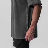Raven Supima oversized tee worn by model, side view showing oversized fit and text graphic