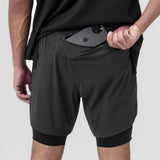 Tetra-Lite 7" Liner Short in Space Grey and Black, model holding phone in front pocket