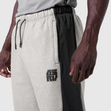 Tech-Terry Mesh Panel Sweats in heather grey with black mesh panels, worn by model, side view