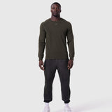 Waffle knit longsleeve in olive worn with black joggers, front view on model