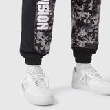 Tech-Terry Mesh Panel Sweats in pixel camo worn with white sneakers, lower body view