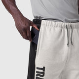 Tech-Terry Mesh Panel Sweats in heather grey, model wearing with hand in pocket detail