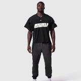 Ion-Mesh Crop Jersey in black with ASTRI text, worn by model with matching joggers, front view