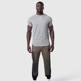 AeroSilver Established Tee in slate grey worn with brown joggers, front view on model